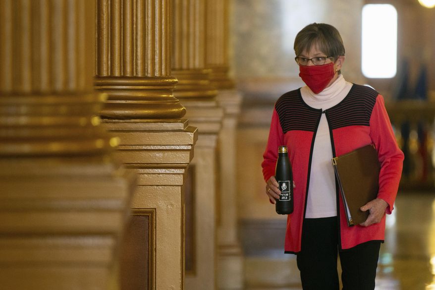 Kansas Gov. Laura Kelly prepares to update the state on COVID-19 cases, Wednesday, Oct. 28, 2020, at the Statehouse in Topeka, Kan. (Evert Nelson/The Topeka Capital-Journal via AP)