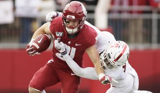 FILE - In this Nov. 16, 2019, file photo, Washington State running back Max Borghi, left, carries the ball during the first half of an NCAA college football game in Pullman, Wash. Borghi is likely to get more rushing attempts under the new Washington coach Nick Rolovich.  (AP Photo/Young Kwak, File)
