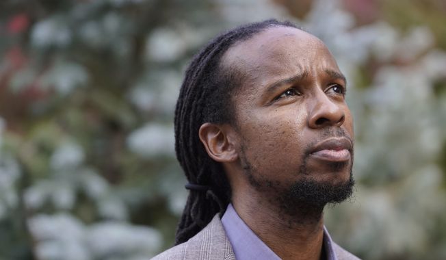 Ibram X. Kendi, director of Boston University&#x27;s Center for Antiracist Research, stands for a portrait Wednesday, Oct. 21, 2020, in Boston. (AP Photo/Steven Senne) ** FILE **