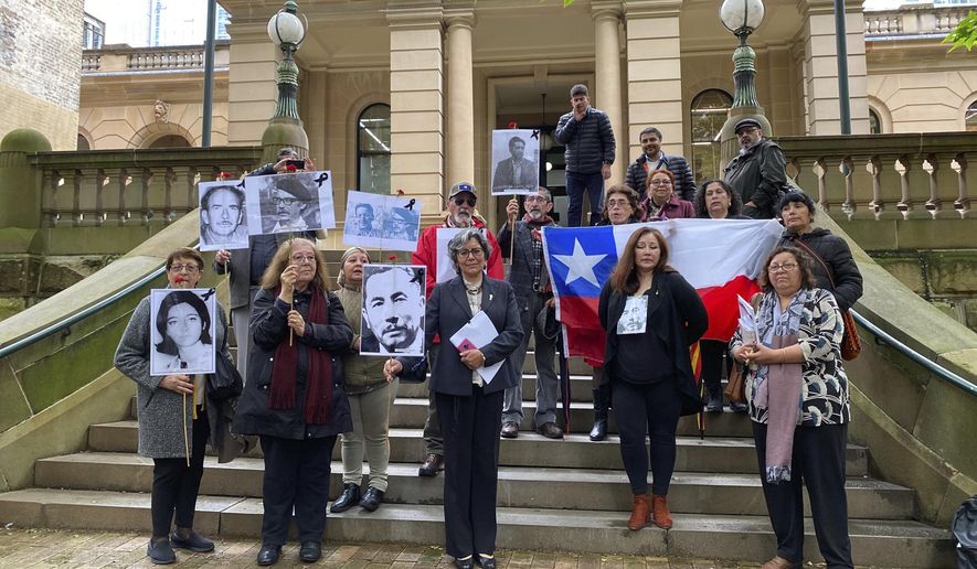 Supporters of those who disappeared in Chile in the 1970&#39;s are seen outside the Sydney Central Local Court in Sydney, Thursday, Oct. 29, 2020.An Australian judge has ruled that a woman wanted in Chile on kidnapping charges dating to Augusto Pinochet’s military dictatorship in the 1970s can be extradited. (Margaret Scheikowski, AAP Image via AP)