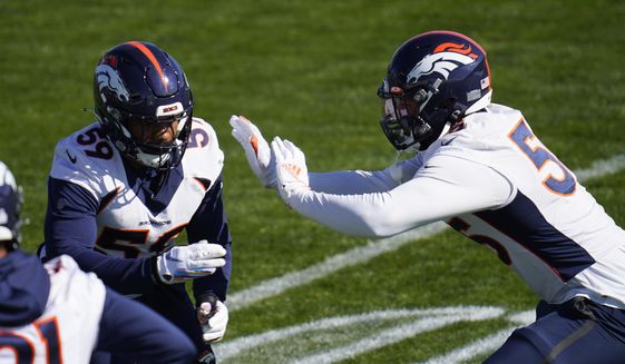 Denver Broncos outside linebackers Malik Reed, left, and Bradley Chubb take part in drills during an NFL football practice Wednesday, Oct. 28, 2020, at the team&#39;s headquarters in Englewood, Colo. (AP Photo/David Zalubowski)