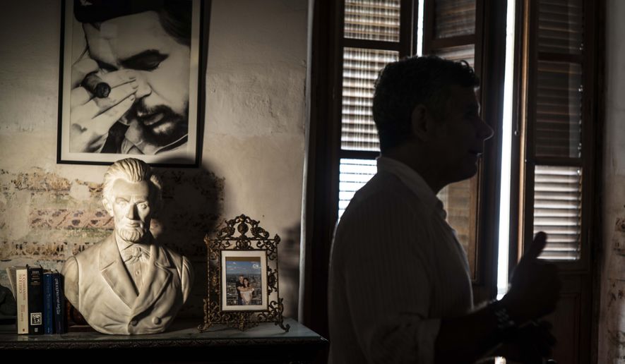 A framed image of Argentine-born Cuban Revolutionary hero Ernesto &amp;quot;Che&amp;quot; Guevara hangs on a wall next to a bust of U.S. President Abraham Lincoln in Gregory Biniowsky&#x27;s house, a Canadian lawyer and consultant who has lived and worked in Cuba for more than 20 years, in Havana, Cuba, Monday, Oct. 19, 2020. Biniowsky said that Trump’s hardline policy toward Cuba prompts a defensive, knee-jerk reaction among officials here wary of changes to the largely state-run economy. (AP Photo/Ramon Espinosa)