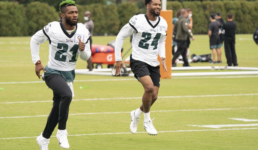Philadelphia Eagles safety Jalen Mills, left, warms up with cornerback Darius Slay, right, during an NFL football practice, Thursday, Sept. 24, 2020, in Philadelphia. (AP Photo/Chris Szagola, Pool)