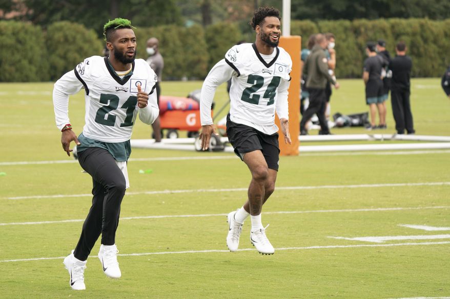 Philadelphia Eagles safety Jalen Mills, left, warms up with cornerback Darius Slay, right, during an NFL football practice, Thursday, Sept. 24, 2020, in Philadelphia. (AP Photo/Chris Szagola, Pool)