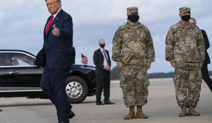 President Donald Trump gives a thumbs up after arriving at Pope Army Field for an event with troops at Fort Bragg, Thursday, Oct. 29, 2020, in Pope Field, N.C. (AP Photo/Evan Vucci)