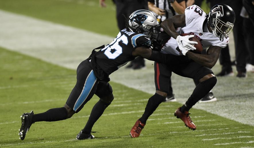 Atlanta Falcons wide receiver Christian Blakeis tackled by Carolina Panthers cornerback Donte Jackson during the first half of an NFL football game Thursday, Oct. 29, 2020, in Charlotte, N.C. (AP Photo/Mike McCarn)