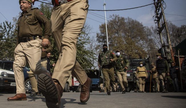 Indian police chase activists of Peoples Democratic party (PDP) protesting against India&#x27;s new land laws that allows any Indian citizen to buy land in the disputed region in Srinagar, Indian controlled Kashmir, Thursday, Oct. 29, 2020. Until last year, Indians were not allowed to buy property in the region. But in August 2019, Prime Minister Narendra Modi’s government scrapped the disputed region’s special status, annulled its separate constitution, split the region into two federal territories. (AP Photo/Mukhtar Khan)