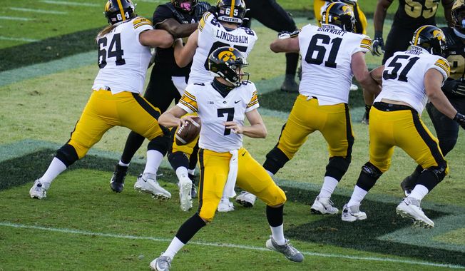 Iowa quarterback Spencer Petras (7) looks to throw against Purdue during the second quarter of an NCAA college football game in West Lafayette, Ind., Saturday, Oct. 24, 2020. (AP Photo/Michael Conroy)
