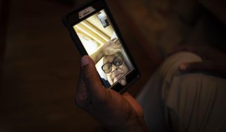 Mike Bishop video chats in Byram, Miss., with his wife, Bonnie Bishop, who is hospitalized 40 miles away, on Thursday, Oct. 8, 2020. He&#39;s hoping she&#39;ll be back by Thanksgiving. (AP Photo/Wong Maye-E)