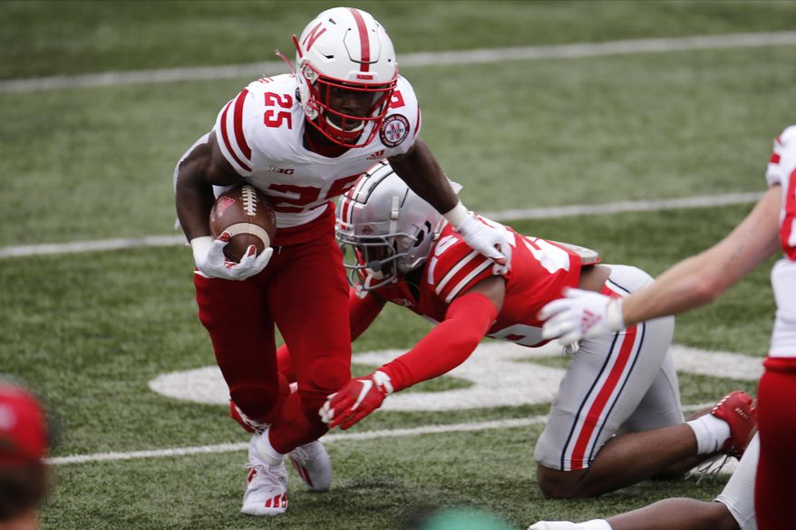 Nebraska running back Ronald Thompkins, left, runs past Ohio State defensive back Lloyd McFarquhar during the second half of an NCAA college football game Saturday, Oct. 24, 2020, in Columbus, Ohio. (AP Photo/Jay LaPrete)