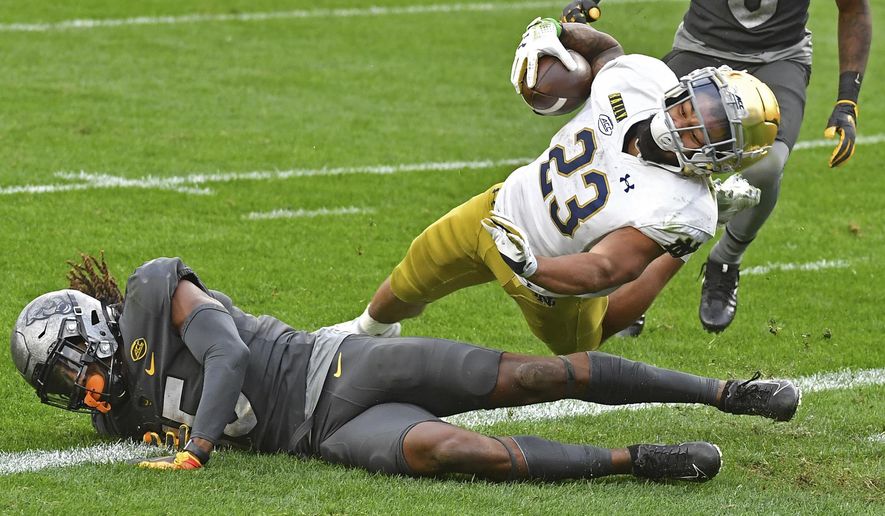 Notre Dame running back Kyren Williams dives into the end zone for a touchdown against Pitt defensive back Jason Pinnock in the second quarter of an NCAA college football game, Saturday, Oct. 24, 2020, in Pittsburgh. (Matt Freed/Pittsburgh Post-Gazette via AP)