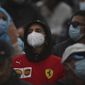 Fans wearing protective face masks watch the Formula One Portuguese Grand Prix at the Algarve International Circuit in Portimao, Portugal, Sunday, Oct. 25, 2020. (Jose Sena Goulao, Pool via AP)