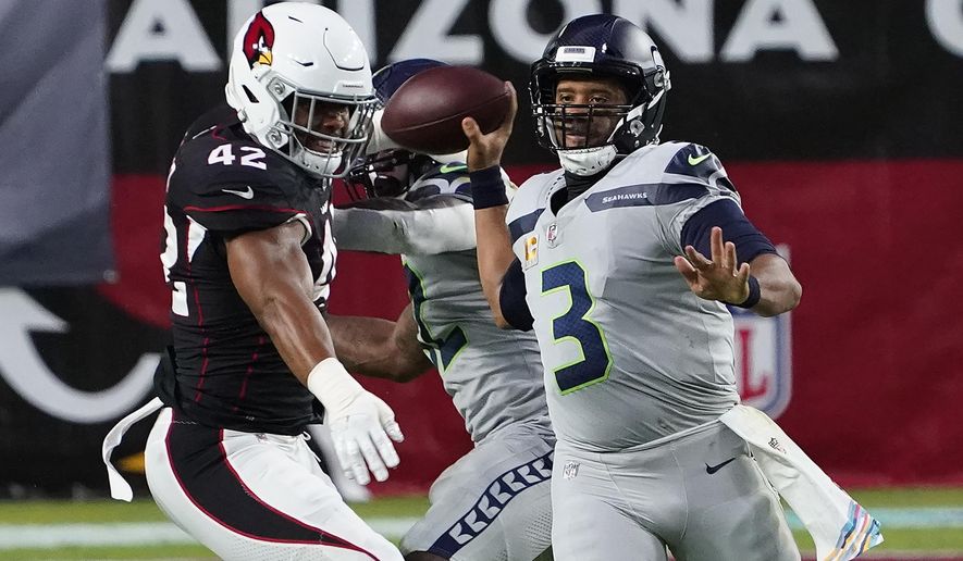 Seattle Seahawks quarterback Russell Wilson (3) throws as Arizona Cardinals outside linebacker Devon Kennard (42) defends during the first half of an NFL football game, Sunday, Oct. 25, 2020, in Glendale, Ariz. (AP Photo/Rick Scuteri)