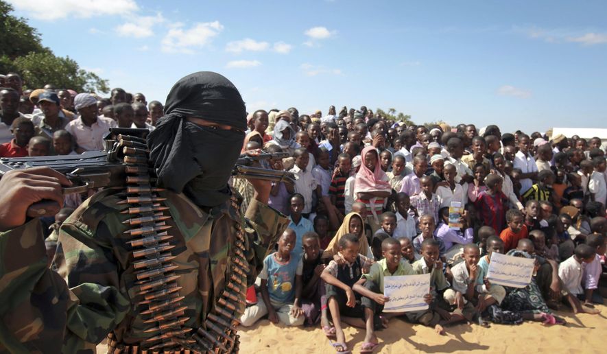 In this Feb. 13, 2012, file photo, an armed member of the militant group al-Shabab attends a rally on the outskirts of Mogadishu, Somalia. (AP Photo, File)  **FILE**