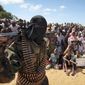 In this Feb. 13, 2012, file photo, an armed member of the militant group al-Shabab attends a rally on the outskirts of Mogadishu, Somalia. (AP Photo, File)  **FILE**