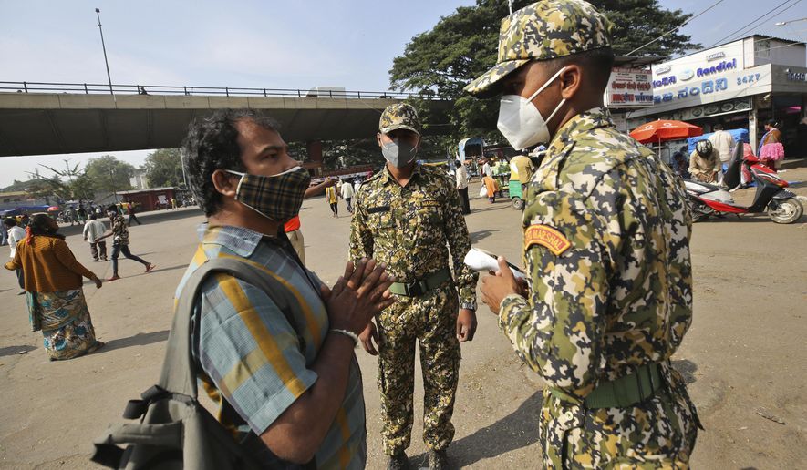 A man pleads with municipal officers as he is fined for not wearing a face mask in Bengaluru, India, Thursday, Oct. 29, 2020. India&#39;s confirmed coronavirus caseload surpassed 8 million on Thursday with daily infections dipping to the lowest level this week, as concerns grew over a major Hindu festival season and winter setting in. (AP Photo/Aijaz Rahi)