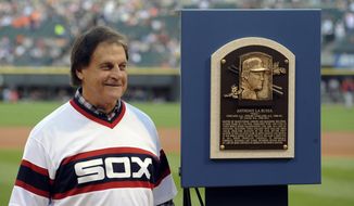 FILE - In this Aug. 30, 2014, file photo, former Chicago White Sox manager Tony La Russa stands with his Baseball Hall of Fame plaque before the second baseball game of a doubleheader against the Detroit Tigers in Chicago. La Russa, the Hall of Famer who won a World Series championship with the Oakland Athletics and two more with the St. Louis Cardinals, is returning to manage the Chicago White Sox 34 years after they fired him, the team announced Thursday, Oct. 29, 2020. (AP Photo/Matt Marton, File)