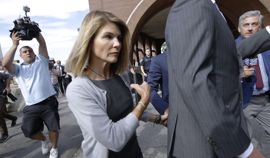 FILE - In this Aug. 27, 2019, file photo, actress Lori Loughlin departs federal court in Boston, after a hearing in a nationwide college admissions bribery scandal. Authorities say the “Full House” actress has reported to a federal prison in California to begin serving her two-month sentence for her role in the college admissions bribery scandal. The U.S. Attorney&#39;s office in Boston said Friday that Loughlin was being processed at the federal lockup in Dublin, California. (AP Photo/Steven Senne, File)