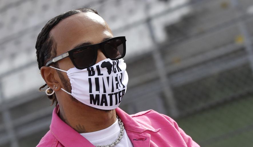 Mercedes driver Lewis Hamilton of Britain wears a protective face mask during track inspection ahead of Sunday's Emilia Romagna Formula One Grand Prix, at the Dino and Enzo Ferrari racetrack, in Imola, Italy, Friday, Oct. 30, 2020. (AP Photo/Luca Bruno)