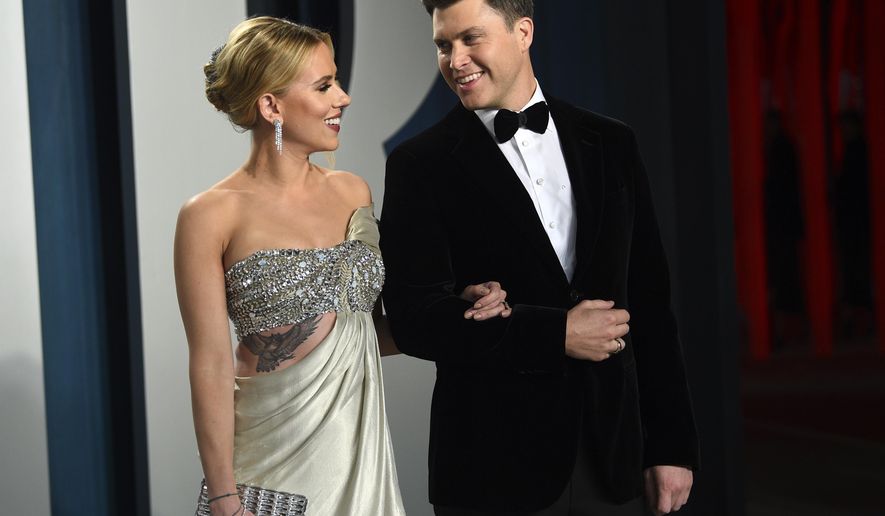 FILE - In this Feb. 9, 2020 file photo, Scarlett Johansson, left, and Colin Jost arrive at the Vanity Fair Oscar Party in Beverly Hills, Calif.  Meals on Wheels America announced Thursday on Instagram that Johansson and Jost married over the weekend in an intimate ceremony. (Photo by Evan Agostini/Invision/AP, FIle)