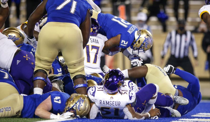 Tulsa running back TK Wilkerson (21) leaps into the end zone for the go-ahead touchdown with under a minute left during an NCAA college football game Friday, Oct. 30, 2020, in Tulsa, Okla. (Ian Maule/Tulsa World via AP)