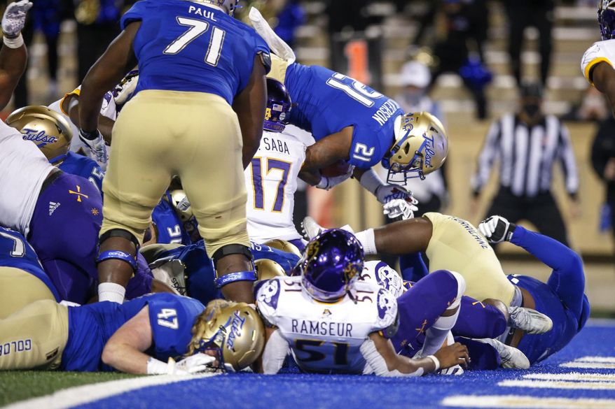Tulsa running back TK Wilkerson (21) leaps into the end zone for the go-ahead touchdown with under a minute left during an NCAA college football game Friday, Oct. 30, 2020, in Tulsa, Okla. (Ian Maule/Tulsa World via AP)