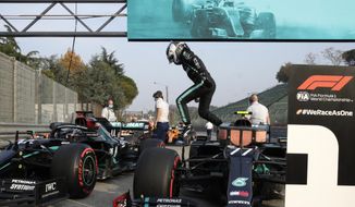 Mercedes driver Valtteri Bottas of Finland jumps out of his car after clocking the fastes time during qualification ahead of Sunday&#39;s Emilia Romagna Formula One Grand Prix, at the Enzo and Dino Ferrari racetrack, in Imola, Italy, Saturday, Oct. 31, 2020. (AP Photo/Luca Bruno, Pool)