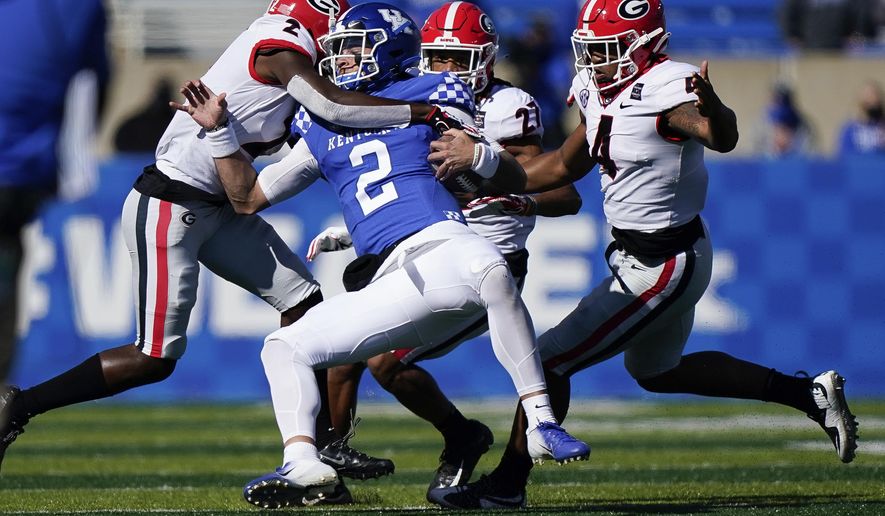 Georgia defensive back Richard LeCounte (2) tackles Kentucky quarterback Joey Gatewood (2) during the first half of an NCAA college football game, Oct. 31, 2020, in Lexington, Ky. (AP Photo/Bryan Woolston)