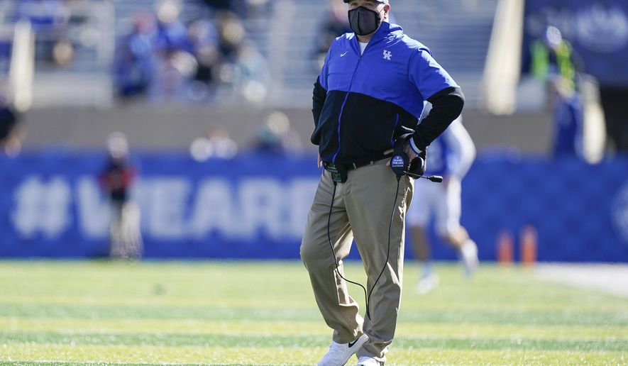 Kentucky head coach Mark Stoops walks on the field during the first half before an NCAA college football game against Georgia, Oct. 31, 2020, in Lexington, Ky. (AP Photo/Bryan Woolston)