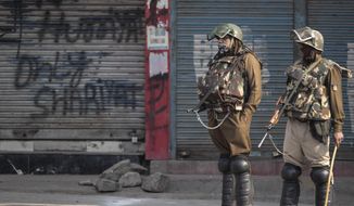 Indian paramilitary soldiers stand guard at a closed market area during a strike called by separatists in Srinagar, Indian controlled Kashmir, Saturday, Oct. 31, 2020. Kashmir’s main separatist grouping called the strike to protest new land laws that India enacted on Tuesday, allowing any of its nationals to buy land in the region. Pro-India politicians in Kashmir have also criticized the laws and accused India of putting Kashmir’s land up for sale. The move exacerbates concerns of Kashmiris and rights groups who see such measures as a settler-colonial project to change the Muslim-majority region’s demography. (AP Photo/Mukhtar Khan)