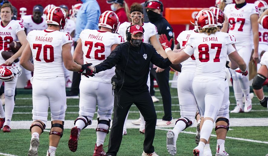 Indiana coach Tom Allen congratulates players during the second quarter of an NCAA college football game against Rutgers, Saturday, Oct. 31, 2020, in Piscataway, N.J. (AP Photo/Corey Sipkin)