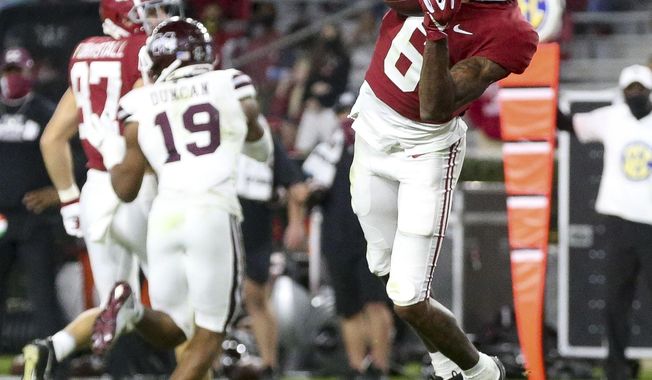 Alabama wide receiver DeVonta Smith (6) catches a touchdown pass with Mississippi State cornerback Emmanuel Forbes (13) defending during an NCAA college football game in Tuscaloosa, Ala., Saturday, Oct. 31, 2020. (Gary Cosby Jr./The Tuscaloosa News via AP)