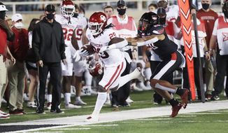Oklahoma running back Rhamondre Stevenson steps out of bounds under pressure from Texas Tech linebacker Kosi Eldridge during the first half of an NCAA college football game Saturday, Oct. 31, 2020, in Lubbock, Texas.(AP Photo/Mark Rogers)