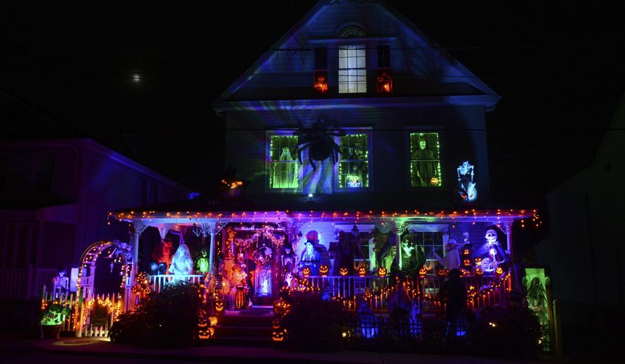 A house along Park Avenue in the Schoentown section of Port Carbon, Pa., is covered in Halloween decorations on Wednesday, Oct. 28, 2020. The backyard is also decorated. (Lindsey Shuey/The Republican-Herald via AP)