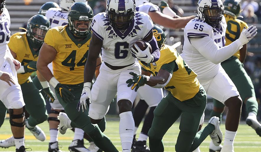 TCU running back Zach Evans (6) runs through the Baylor defense in the first half of an NCAA college football game in Waco, Texas, Saturday, Oct. 31, 2020. (Jerry Larson/Waco Tribune-Herald via AP)