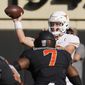 Texas quarterback Sam Ehlinger throws under pressure from Oklahoma State linebacker Amen Ogbongbemiga (7) during the first half of an NCAA college football game in Stillwater, Okla., Saturday, Oct. 31, 2020. (AP Photo/Sue Ogrocki)