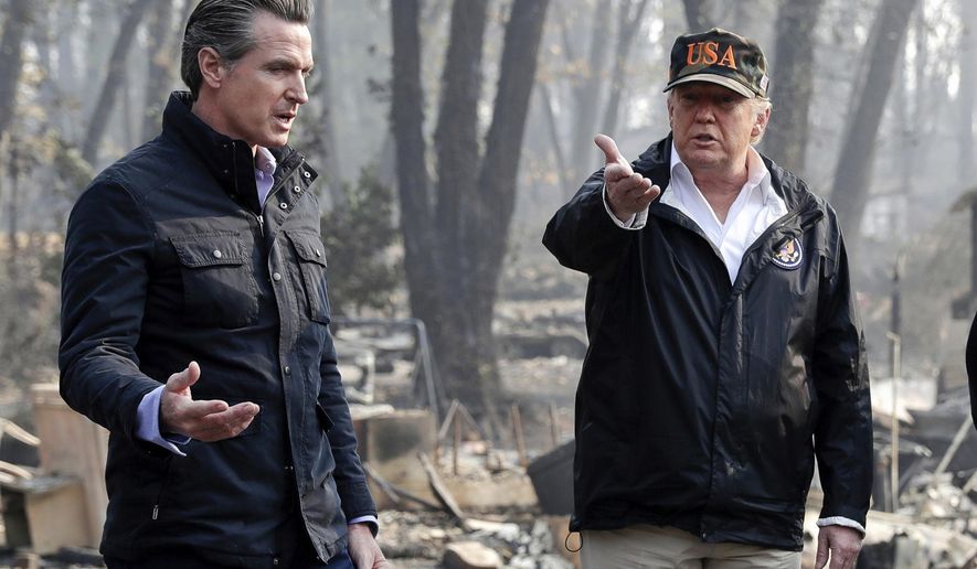 FILE - In this Nov. 17, 2018, file photo, President Donald Trump talks with then California Gov.-elect Gavin Newsom, left, during a visit to a neighborhood impacted by the wildfires in Paradise, Calif. Nearly two years ago President Trump ordered the U.S. Forest Service and the Department of Interior to make federal lands less susceptible to catastrophic wildfires. But the agencies fell short of his goals in 2019, treating a combined 4.3 million acres — just over half of the 8.45 million acres the president sought. It was only slightly better than their average annual performance over nearly two decades, according to government data. (AP Photo/Evan Vucci, File)