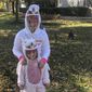 In this file photo,ten-year-old Cameron Fox and her 4-year-old sister, Lexi, of Brookfield, Ill., are dressed as unicorns for Halloween with plastic face shields to protect against COVID-19, as they visit the home of family friends in nearby River Forest, Ill., on Saturday, Oct. 31, 2020.  While this year many Americans are eager to resume Halloween traditions shelved because of the pandemic, an ongoing supply-chain crunch has resulted in party-supply stores nationwide running out of the most coveted mass-produced costumes.  (AP Photo/Don Babwin)  **FILE**
