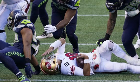 San Francisco 49ers quarterback Jimmy Garoppolo reacts after he was sacked by Seattle Seahawks middle linebacker Bobby Wagner during the first half of an NFL football game, Sunday, Nov. 1, 2020, in Seattle. (AP Photo/Elaine Thompson)