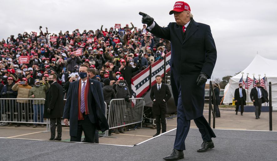 President Donald Trump arrives for a campaign rally at Michigan Sports Stars Park, Sunday, Nov. 1, 2020, in Washington, Mich. (AP Photo/Evan Vucci)