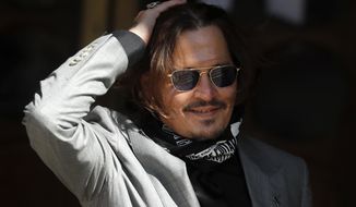 FILE - In this file photo dated Tuesday, July 28, 2020, US Actor Johnny Depp arrives at the High Court in London during his case against News Group Newspapers over a story published about his former wife Amber Heard, which branded him a &#39;wife beater&#39;.  A British judge is set to deliver his judgement in writing on Monday Nov. 2, 2020, deciding whether a tabloid newspaper defamed Depp by calling him a “wife beater.&amp;quot;  (AP Photo/Frank Augstein, FILE)