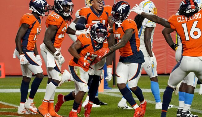 Denver Broncos wide receiver K.J. Hamler (13) celebrates his game-tying touchdown with teammates during the second half of an NFL football game against the Los Angeles Chargers, Sunday, Nov. 1, 2020, in Denver. The Broncos won 31-30. (AP Photo/Jack Dempsey)