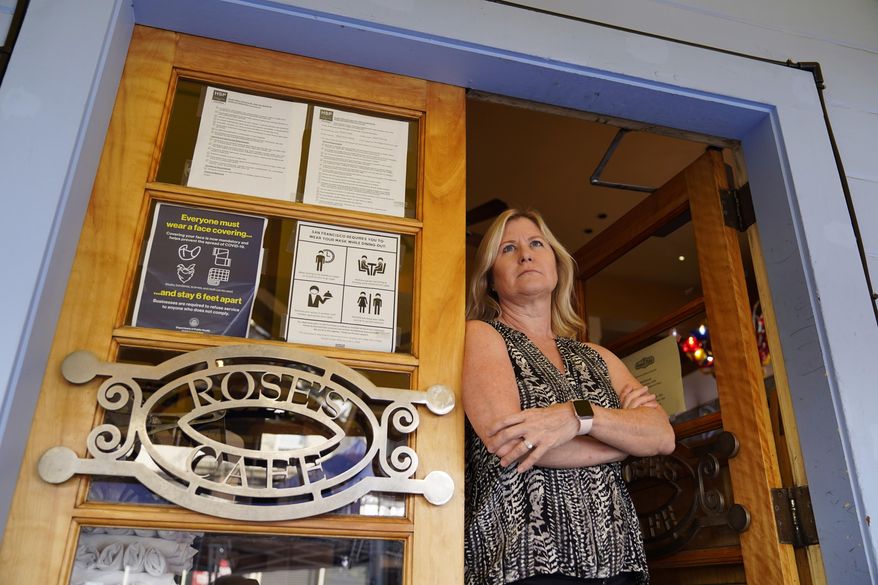 FILE - In this Sept. 28, 2020 file photo Laurie Thomas poses by an entryway to her Rose's Cafe restaurant, in San Francisco. A new generation of California voters is being asked to roll back affirmative action and property tax laws put in place decades ago in an election that will test the boundaries of the state's left-leaning politics. (AP Photo/Eric Risberg, File)