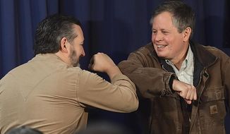 In this Thursday, Oct. 29, 2020, photo, Republican Senators, Ted Cruz, left, of Texas and Steve Daines of Montana, bump elbows during a campaign rally in Billings, Mont. Sen. Daines is being challenged in Tuesday&#39;s election by Montana Gov. Steve Bullock, a Democrat. (Larry Mayer/The Billings Gazette via AP)