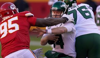 Kansas City Chiefs defensive tackle Chris Jones (95) pressures as New York Jets quarterback Sam Darnold (14) fights out of Jones&#39; grasp in the second half of an NFL football game on Sunday, Nov. 1, 2020, in Kansas City, Mo. (AP Photo/Charlie Riedel)
