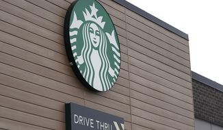 FILE - This Oct. 27, 2020, file photo shows a sign at a Starbucks Coffee store in south Seattle. Starbucks said Monday, Nov. 2, 2020, it plans to open an outlet in Laos as it expands its more than 10,000 stores in Asian countries. The company said it plans to open the shop in the Laotian capital Vientiane by next summer. (AP Photo/Ted S. Warren, File)