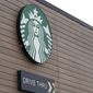 FILE - This Oct. 27, 2020, file photo shows a sign at a Starbucks Coffee store in south Seattle. Starbucks said Monday, Nov. 2, 2020, it plans to open an outlet in Laos as it expands its more than 10,000 stores in Asian countries. The company said it plans to open the shop in the Laotian capital Vientiane by next summer. (AP Photo/Ted S. Warren, File)
