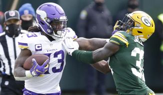 Minnesota Vikings&#39; Dalvin Cook tries to get padt Green Bay Packers&#39; Josh Jackson during the second half of an NFL football game Sunday, Nov. 1, 2020, in Green Bay, Wis. (AP Photo/Mike Roemer)