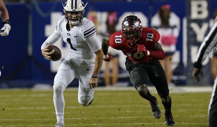 BYU quarterback Zach Wilson (1) out runs Western Kentucky defensive end DeAngelo Malone (10) during the first half of an NCAA college football game Saturday, Oct. 31, 2020, in Provo, Utah. (AP Photo/Rick Bowmer, Pool)