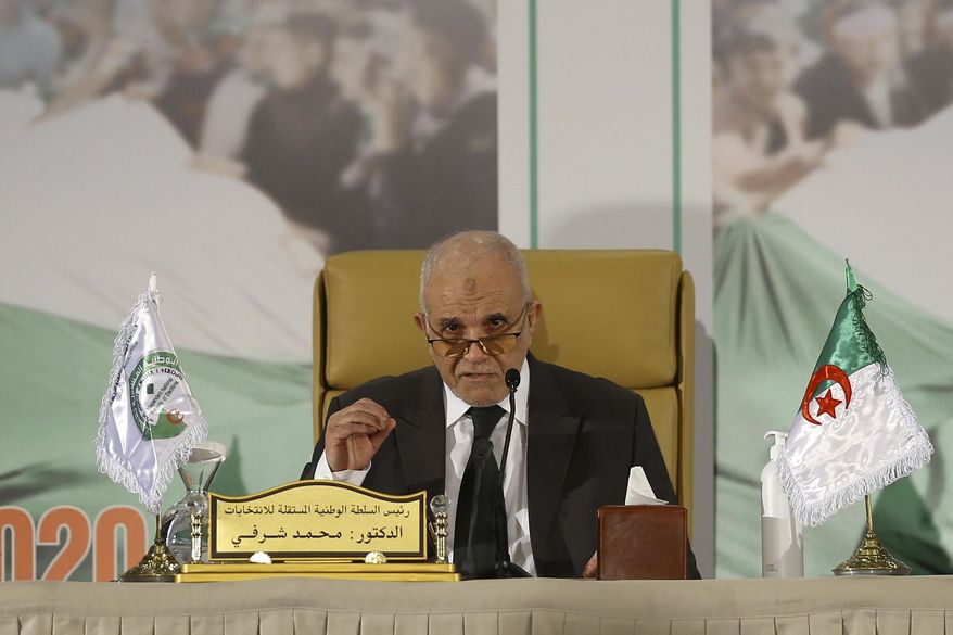 Mohamed Charfi , head of the Algerian Elections National Authority announces the results of the referendum in Algiers, Monday, Nov.2, 2020. Algerians have approved a revised constitution that imposes term limits and is aimed at answering demands from pro-democracy protesters who pushed out the president last year. (AP Photo/Anis Belghoul)